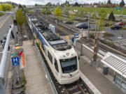 A MAX Green Line train pulls into the Southeast Main Street station near Mall 205 in Portland.