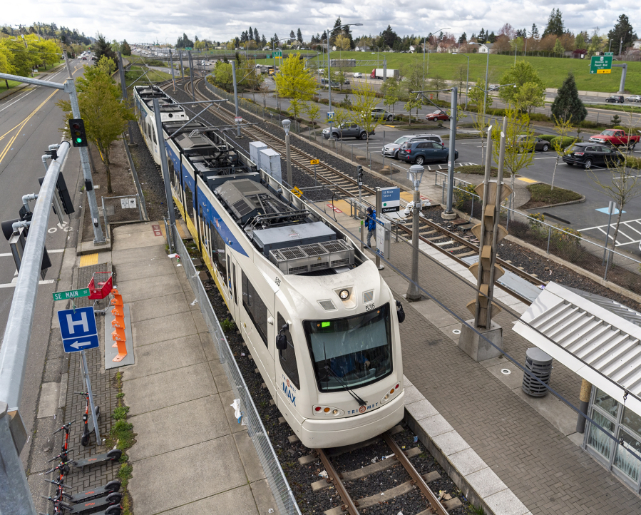 A MAX Green Line train pulls into the Southeast Main Street station near Mall 205 in Portland.