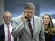 Sen. Joe Manchin (D-WV) talks on the phone as he walks through the Senate subway on his way to a lunch meeting with Senate Democrats at the U.S. Capitol on June 14, 2022, in Washington, D.C.