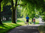 Joggers run through Centennial Park along Elliott Bay Trail in Seattle on July 5, 2022.