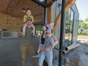 After three years of planning and construction, Ashwood Taps and Trucks is anticipating an early August opening. Owners Tyler and Megan Davis with their children McCall, 4, and Rhettic, 3,   show off the nearly completed project.