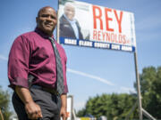 Clark County sheriff candidate Rey Reynolds stands in front of a campaign sign in Walnut Grove.