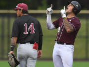 Raptors first baseman Safea Mauai, right, points and celebrates after a hit Wednesday, July 6, 2022, during a game between the Ridgefield Raptors and the Corvallis Knights at the Ridgefield Outdoor Recreation Complex.