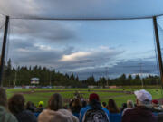 Fans watch a baseball game between the Ridgefield Raptors and the Corvallis Knights under partly cloudy skies Wednesday, July 6, 2022, at the Ridgefield Outdoor Recreation Complex.