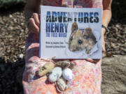 Sue Dockstader holds "The Adventures of Henry the Field Mouse," written by her English mother, Jo Coker, along with Coker's hand-knitted mice. The stories are compiled from letters that Coker wrote to Dockstader's children 20 years ago.