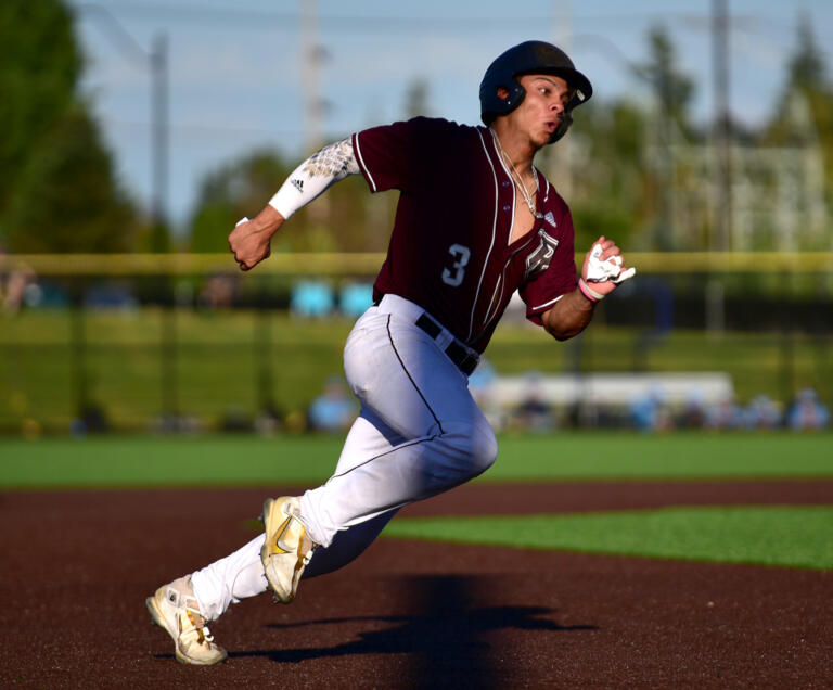 Raptors catcher Jacob Sharp rounds third base on his way home Tuesday, July 12, 2022, during a game between the Ridgefield Raptors and the Bellingham Bells at the Ridgefield Outdoor Recreation Complex.