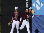 Raptors right fielder Trent Prokes, left, watches as center fielder Austin Caviness throws the ball Tuesday, July 12, 2022, during a game between the Ridgefield Raptors and the Bellingham Bells at the Ridgefield Outdoor Recreation Complex.