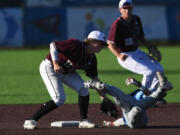 Raptors second baseman Nate Kirkpatrick tags out a tumbling Bellingham baserunner Tuesday, July 12, 2022, during a game between the Ridgefield Raptors and the Bellingham Bells at the Ridgefield Outdoor Recreation Complex.