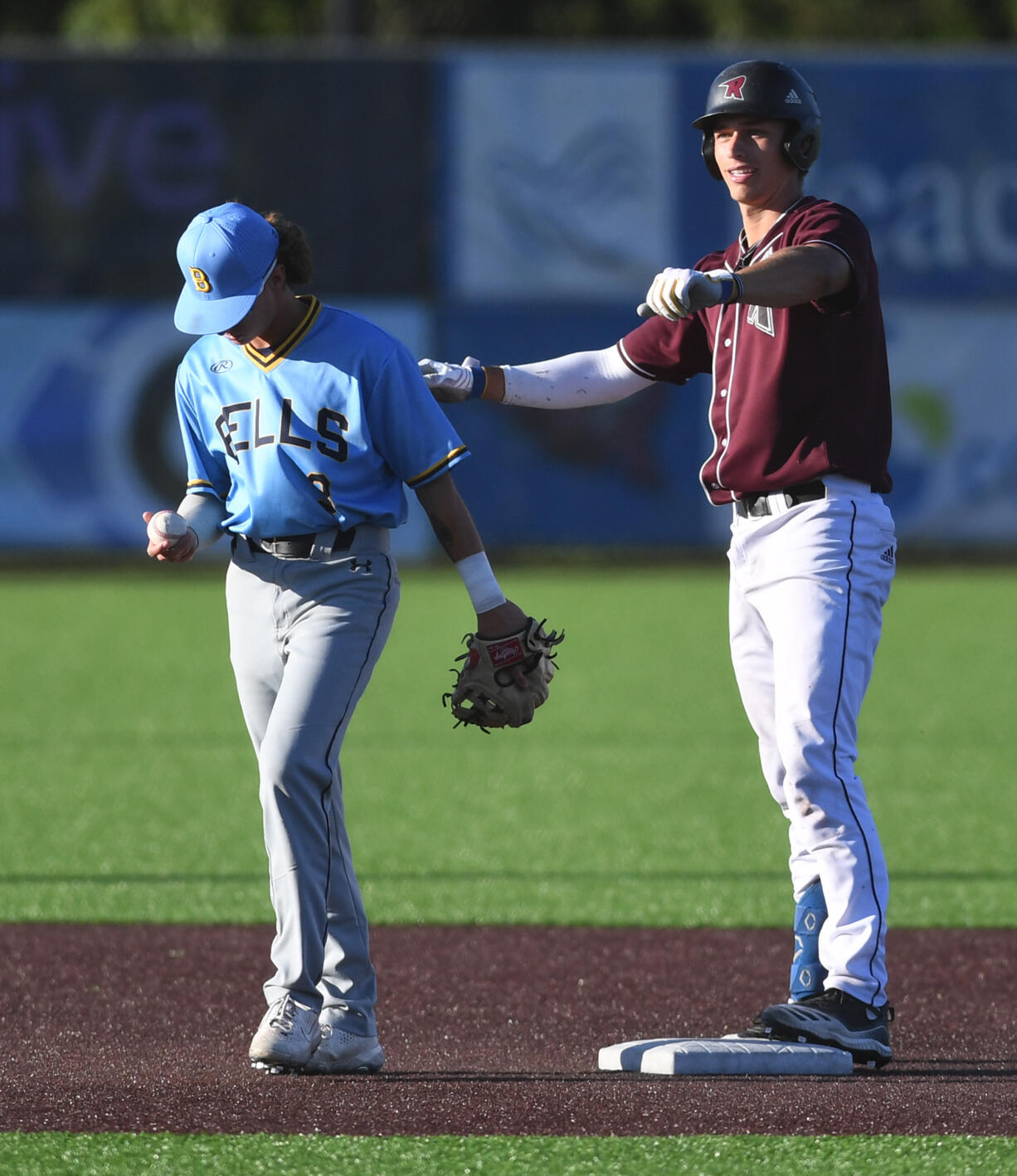 Raptors third baseman Justin Trimble, right, celebrates after a double Tuesday, July 12, 2022, during a game between the Ridgefield Raptors and the Bellingham Bells at the Ridgefield Outdoor Recreation Complex.