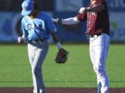 Raptors third baseman Justin Trimble, right, celebrates after a double Tuesday, July 12, 2022, during a game between the Ridgefield Raptors and the Bellingham Bells at the Ridgefield Outdoor Recreation Complex.