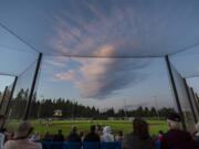 The sunset illuminates a cloud over the Ridgefield Outdoor Recreation Complex on Tuesday, July 12, 2022, during a game between the Ridgefield Raptors and the Bellingham Bells.