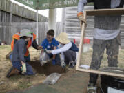 Pippin Casimir, 8, from left, Hudson Beal, 10, Ariana Ramunno-Johnson, 10, and Danny Ramunno-Johnson, 8, work together to identify artifacts in their excavation site at Fort Vancouver National Historic Site on Saturday, July 16, 2022.