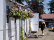 Colorful summer flower baskets hang from units at Living Hope Safe Stay Community on Thursday afternoon. The number of households experiencing homelessness in Clark County increased by 1.6 percent from 2020 to 2021, but the number of people new to homelessness fell by 8 percent, a testament to the effectiveness of federal and state efforts to keep people from falling into homelessness during the COVID-19 pandemic, according to Council for the Homeless' 2021 Homeless Crisis Response System Report, which was published this month.