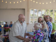 Eric Erickson of CDM Caregiving Services, left, shakes hands with community leader Pat Jollota, second from left, after receiving the Pat Jollota Leadership Award during the 2022 Senior Hero Awards at Pearson Air Museum on Wednesday afternoon. Erickson was recognized for his more than 20 years of service with CDM Caregiving Services. "I used to work as a work study student at Western Washington University, and my boss there made me love serving seniors," Erickson said. "If you know a young person just getting into this line of service, make them love it.