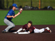 Raptors shortstop Travis Welker, right, slides safely into second base Friday, July 15, during a game between the Raptors and the Springfield Drifters at the Ridgefield Outdoor Recreation Center.