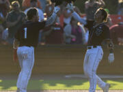 Raptors catcher Jacob Sharp, right, celebrates with shortstop Travis Welker on Tuesday, July 26, 2022, after Sharp hit a home run in a game between Ridgefield and the Bend Elks at the Ridgefield Outdoor Recreation Complex.