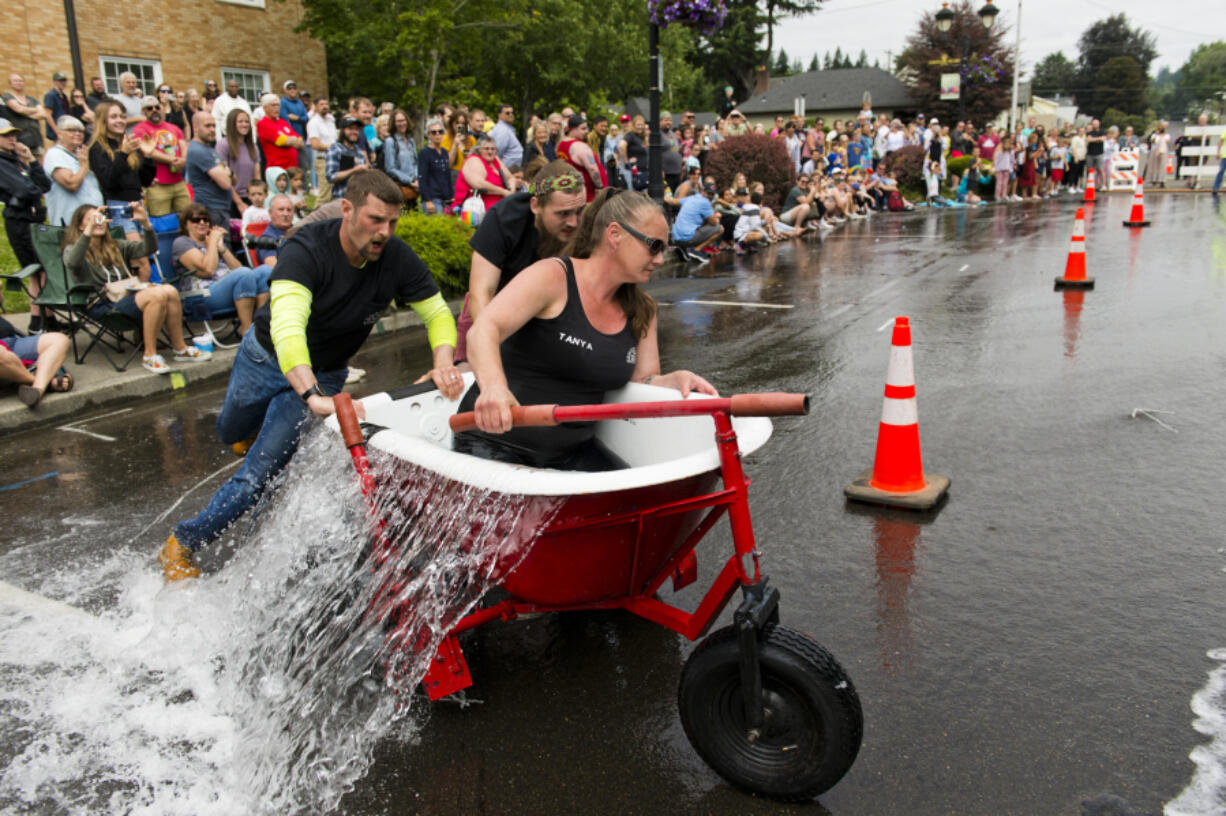 This year's champion, Chuck's Towing -- Tanya Groth, Greg Irwin and their son, at center, Tristan Groth -- makes the turn to head back for the second leg of the race.