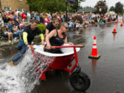 This year's champion, Chuck's Towing -- Tanya Groth, Greg Irwin and their son, at center, Tristan Groth -- makes the turn to head back for the second leg of the race.