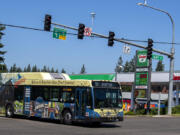 A C-Tran bus passes a Sinclair gas station near Fisher's Landing Transit Center on Tuesday morning.