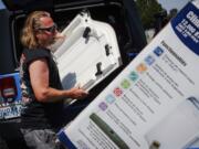 Brian Gadzuk, 56, clears out the trunk of his Jeep to make space for a new air conditioning unit in the parking lot of McLendon Hardware in Renton, Wash., on Sunday, July 24, 2022. The Pacific Northwest is bracing for a major heat wave, with temperatures forecast to top 100 degrees Fahrenheit (37.8 Celsius) in some places this week as climate change fuels longer hot spells in a region where such events were historically uncommon.