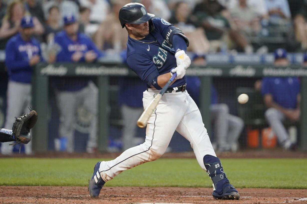 Seattle Mariners' Ty France hits a solo home run against the Texas Rangers during the fifth inning of a baseball game, Monday, July 25, 2022, in Seattle. (AP Photo/Ted S.