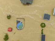 Home and structures are flooded near Quicksand, Ky., Thursday, July 28, 2022. Heavy rains have caused flash flooding and mudslides as storms pound parts of central Appalachia. Kentucky Gov. Andy Beshear says it's some of the worst flooding in state history. (Ryan C.