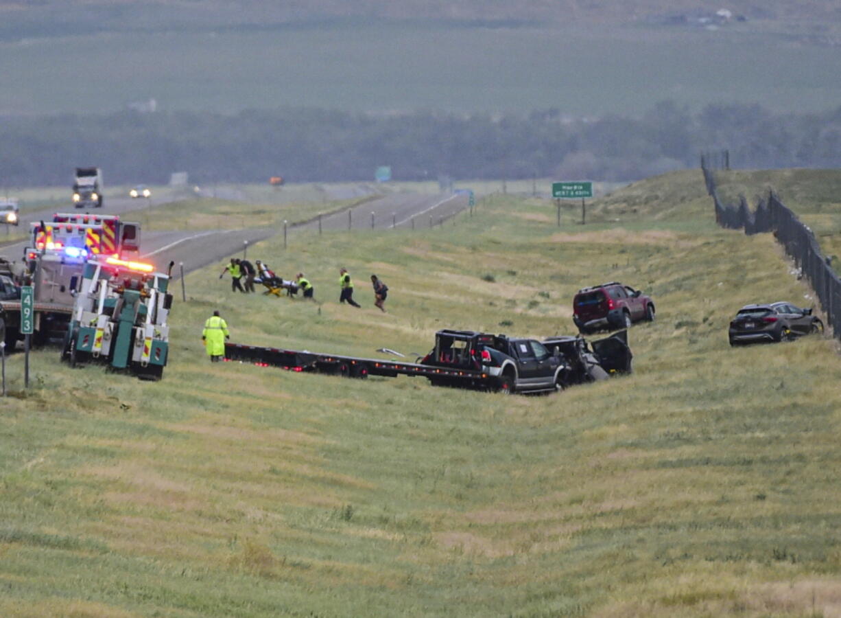 First responders work the scene on Interstate 90 after a fatal pileup where at least 20 vehicles crashed near Hardin, Mont., Friday, July 15, 2022.