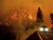 A firetruck drives along California Highway 96 as the McKinney Fire burns in Klamath National Forest, Calif., Saturday, July 30, 2022.