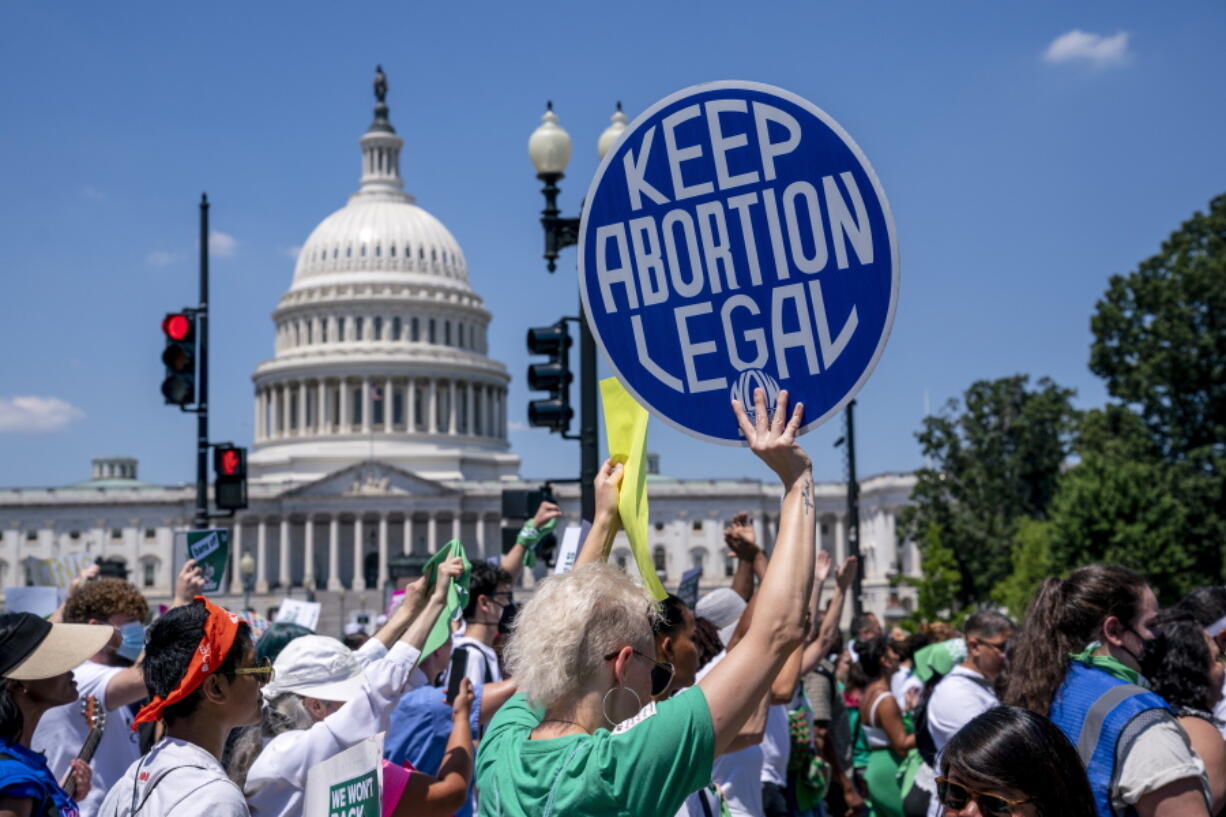 FILE - Abortion-rights activists demonstrate against the Supreme Court decision to overturn Roe v. Wade that established a constitutional right to abortion, on Capitol Hill in Washington, June 30, 2022. A majority of Americans say Congress should pass a law guaranteeing access to legal abortion nationwide. That's according to a new poll from The Associated Press-NORC Center for Public Affairs Research. (AP Photo/J.