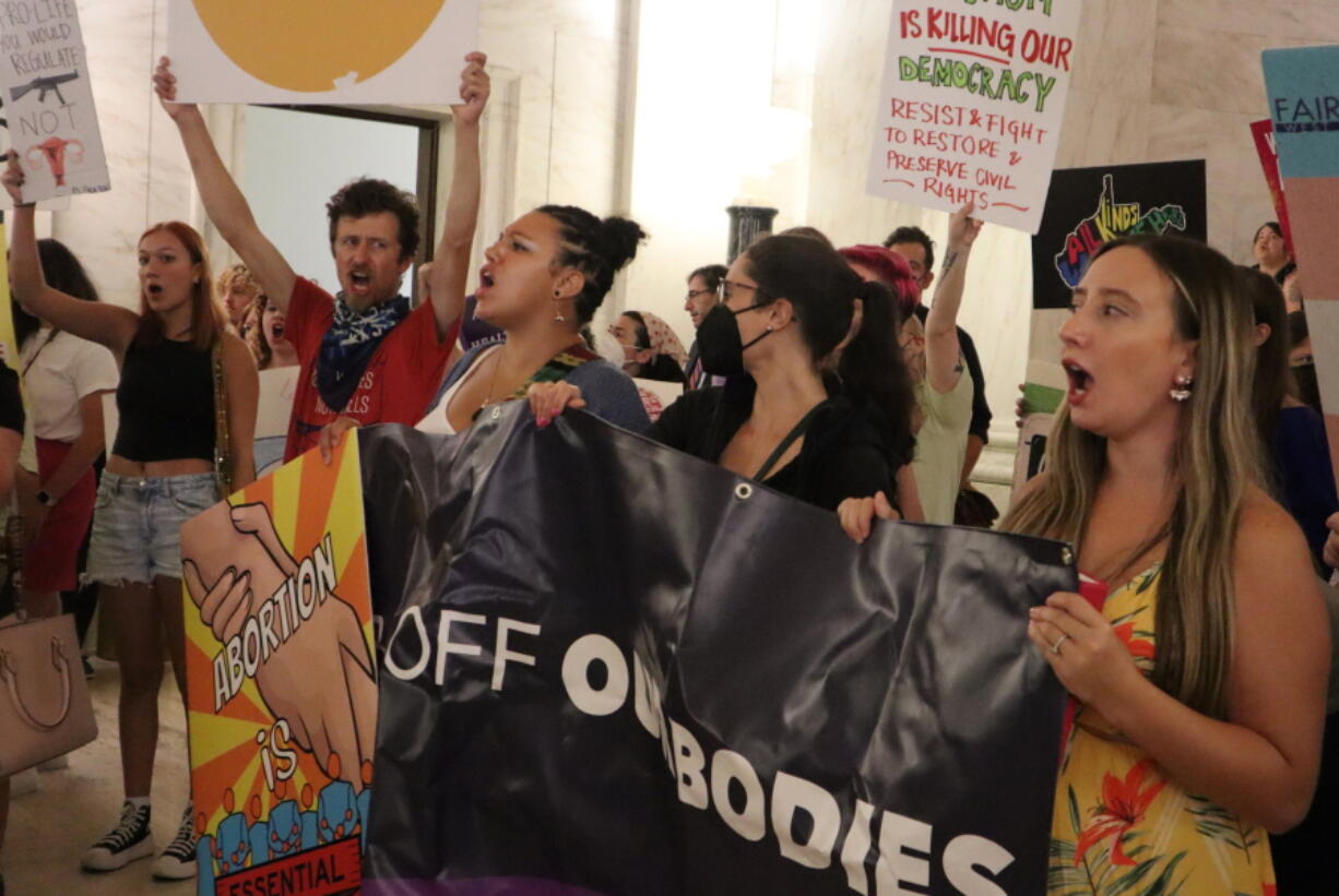 A group gathers to protest a sweeping abortion ban bill making its way through the West Virginia Legislature at the state Capitol on Wednesday, July 27, 2022 in Charleston, W.Va.