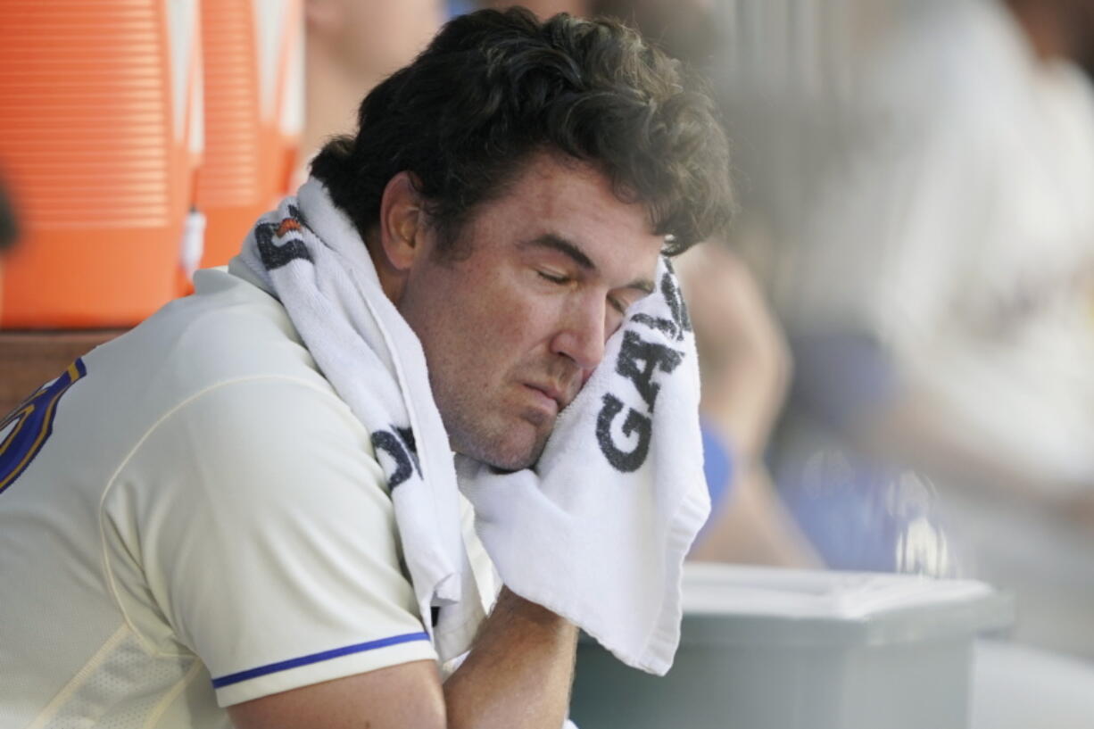 Seattle Mariners starting pitcher Robbie Ray wipes his face with a towel in the dugout after the top of the first inning of a baseball game against the Houston Astros, Sunday, July 24, 2022, in Seattle. (AP Photo/Ted S.