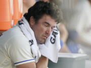 Seattle Mariners starting pitcher Robbie Ray wipes his face with a towel in the dugout after the top of the first inning of a baseball game against the Houston Astros, Sunday, July 24, 2022, in Seattle. (AP Photo/Ted S.