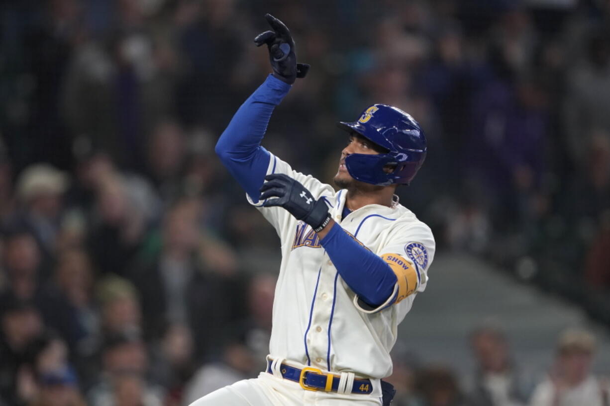 Seattle Mariners' Julio Rodriguez gestures after crossing the plate after he hit a solo home run against the Oakland Athletics during the first inning of a baseball game, Sunday, July 3, 2022, in Seattle. (AP Photo/Ted S.