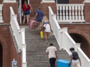 Incoming students, parents and volunteers move items into the dorms at Emory & Henry College, Aug. 12, 2021, in Emory, Va. It's dorm shopping season for parents sending their kids off to college.