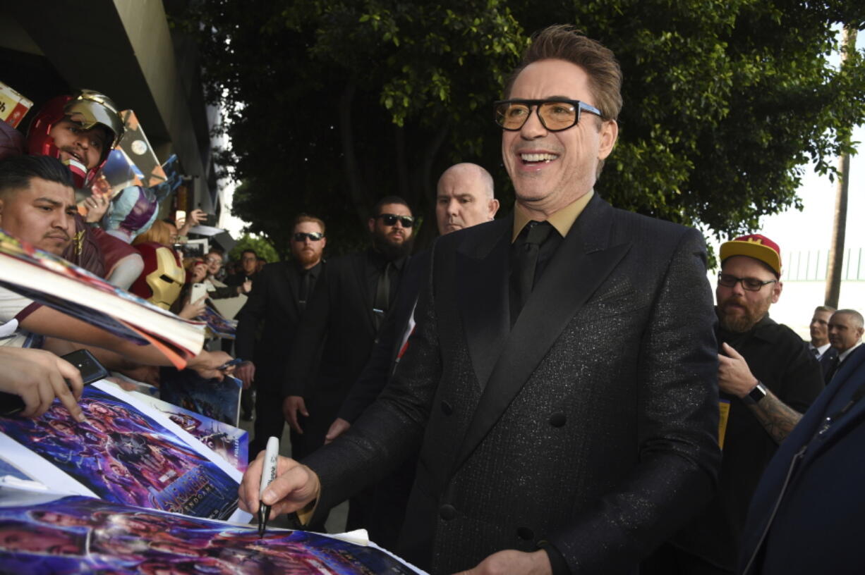 FILE - Robert Downey Jr. signs autographs as he arrives at the premiere of "Avengers: Endgame" at the Los Angeles Convention Center, April 22, 2019. The Energy Department is teaming with actor Robert Downey Jr. to recruit up to 1,000 new workers focused on climate change and clean energy. Energy Secretary Jennifer Granholm on Wednesday, July 6, 2022, released a video with the "Iron Man" actor encouraging applicants from diverse backgrounds to join the department's "clean energy corps" and take on jobs aimed at accelerating deployment of clean energy such as wind and solar power.