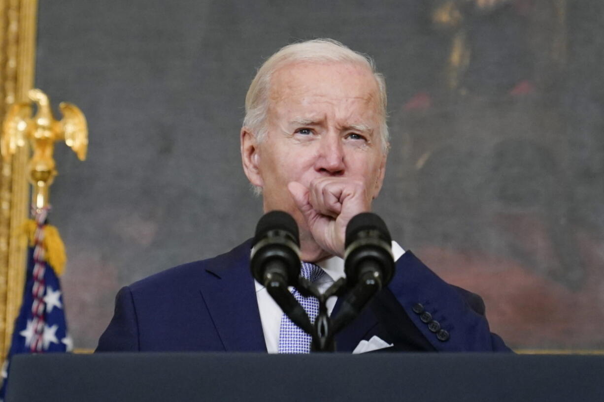 FILE - President Joe Biden coughs as he speaks about "The Inflation Reduction Act of 2022" in the State Dining Room of the White House in Washington, Thursday, July 28, 2022. Biden tested positive for COVID-19 again Saturday, July 30, slightly more than three days after he was cleared to exit coronavirus isolation, the White House said, in a rare case of "rebound" following treatment with an anti-viral drug.