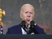 FILE - President Joe Biden coughs as he speaks about "The Inflation Reduction Act of 2022" in the State Dining Room of the White House in Washington, Thursday, July 28, 2022. Biden tested positive for COVID-19 again Saturday, July 30, slightly more than three days after he was cleared to exit coronavirus isolation, the White House said, in a rare case of "rebound" following treatment with an anti-viral drug.