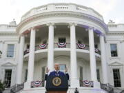 FILE - President Joe Biden speaks during an Independence Day celebration on the South Lawn of the White House, July 4, 2021, in Washington. Last Fourth of July, Biden gathered hundreds of people outside the White House for an event that would have been unthinkable for many Americans the previous year. With the coronavirus in retreat, they ate hamburgers and watched fireworks over the National Mall.