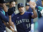 Seattle Mariners starting pitcher Robbie Ray is greeted in the dugout after getting out of a based-loaded jam in the fifth inning of the team's baseball game against the Toronto Blue Jays, Saturday, July 9, 2022, in Seattle. (AP Photo/Ted S.