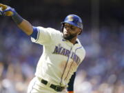 Seattle Mariners' Carlos Santana gestures as he heads to first after hitting a two-run home run against the Toronto Blue Jays during the eighth inning of a baseball game, Sunday, July 10, 2022, in Seattle. Santana had two home runs and the Mariners won 6-5. (AP Photo/Ted S.