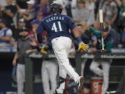 Seattle Mariners' Carlos Santana tosses his bat after he hit a two-run home run during the seventh inning of the team's baseball game against the Toronto Blue Jays, Saturday, July 9, 2022, in Seattle. (AP Photo/Ted S.