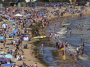 Crowds gather at the beach during a heat wave Saturday in Broadstairs,  England. Temperatures may reach 104 degrees Monday and Tuesday, which would be a record high.