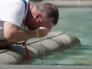 A man refreshes his face at a fountain in Trafalgar Square in central London, Tuesday, July 19, 2022. Britain shattered its record for highest temperature ever registered Tuesday, with a provisional reading of 39.1 degrees Celsius (102.4 degrees Fahrenheit), according to the country's weather office -- and the heat was only expected to rise.