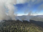 In this image released by the National Park Service, smoke rises from the Washburn Fire near the lower portion of the Mariposa Grove in Yosemite National Park, Calif., Friday, July 8, 2022. Part of Yosemite National Park has been closed as a wildfire quintupled in size near a grove of California's famous giant sequoia trees, officials said.