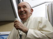 Pope Francis speaks to journalists aboard the papal flight back from Canada Saturday, July 30, 2022, where he paid a six-day pastoral visit.