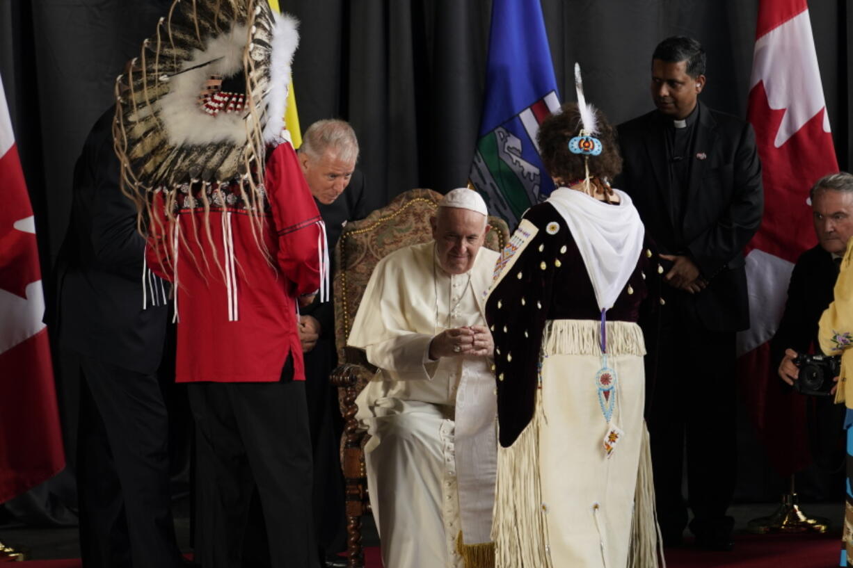 Pope Francis is welcomed by a group of Indigenous leaders Sunday, July 24, 2022, in Edmonton, Alberta, Canada.