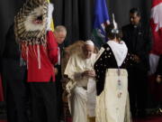 Pope Francis is welcomed by a group of Indigenous leaders Sunday, July 24, 2022, in Edmonton, Alberta, Canada.