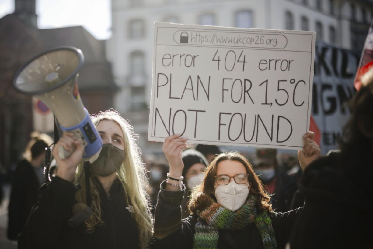 FILE - People attend a Climate Strike demonstration in Zurich, Switzerland, Nov. 6, 2021. The world's most influential banks need to substantially accelerate climate efforts if global temperature rise is to be kept within the livability targets of the Paris Agreement, an assessment released Thursday, July 28, 2022, by an institutional investors' group warned.