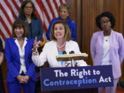 Speaker of the House Nancy Pelosi, D-Calif., makes a point during an event with Democratic women House members and advocates for reproductive freedom ahead of the vote on the Right to Contraception Act, at the Capitol in Washington, Wednesday, July 20, 2022. She is flanked by Rep. Kathy Manning, D-N.C., and Rep. Lauren Underwood, D-Ill. Democrats are pushing legislation through the House that would inscribe the right to use contraceptives into law. (AP Photo/J.