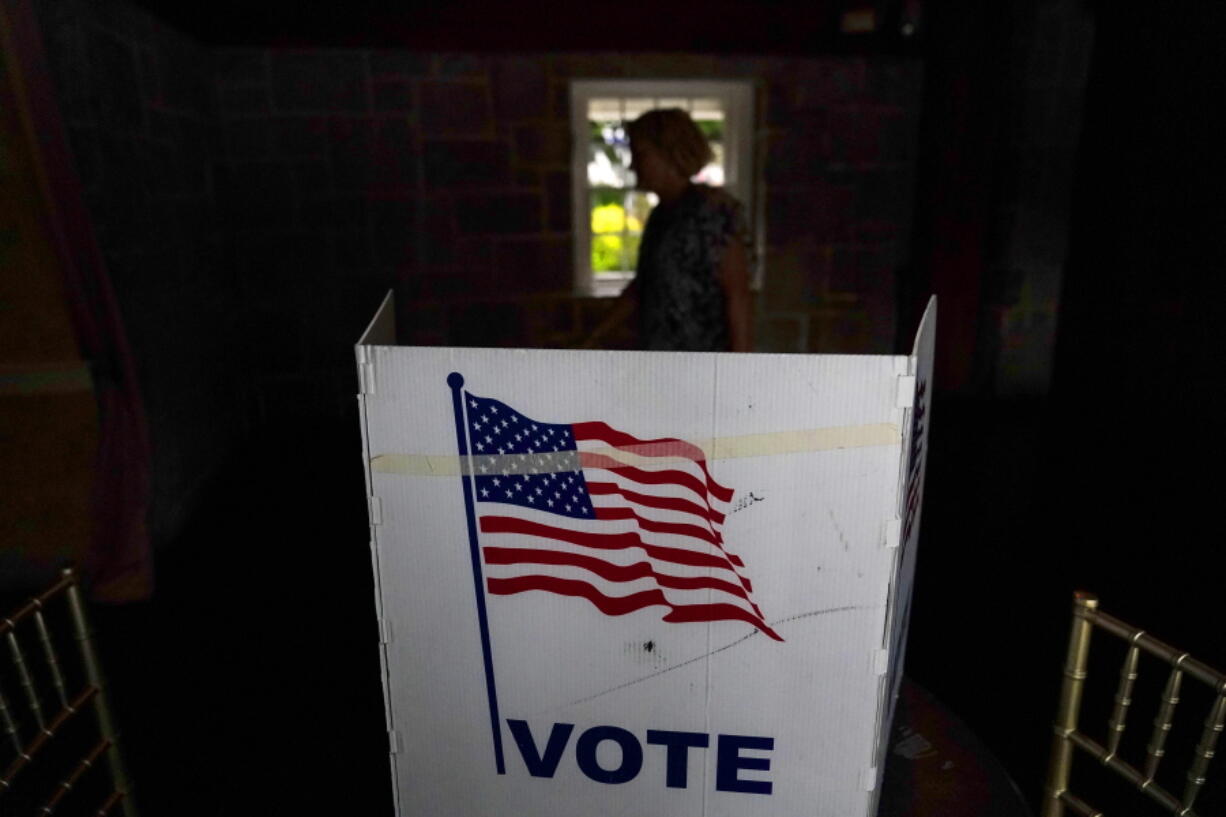 FILE - A person waits in line to vote in the Georgia's primary election on May 24, 2022, in Atlanta. More than 1 million voters across 43 states have switched to the Republican Party over the last year, according to voter registration data analyzed by The Associated Press.